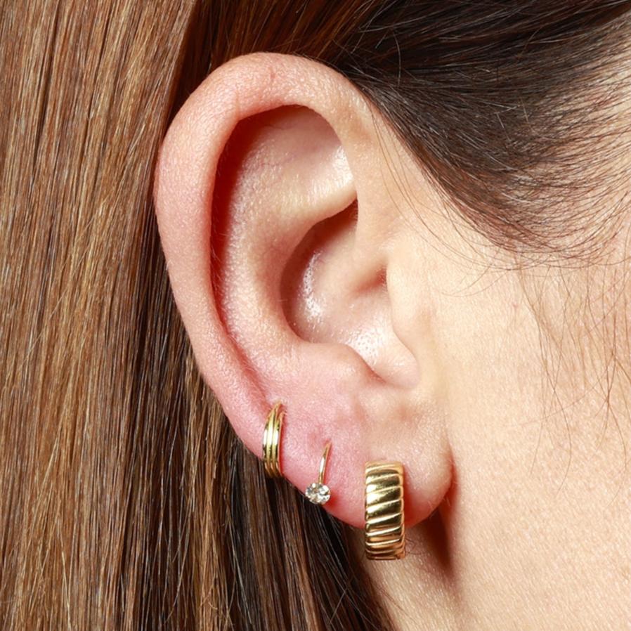 pendiente de piericing con aro flexible y brillante que es fácil de poner. es de plata de ley con baño de oro 18 kilates. Gold hoop huggie piercing earring