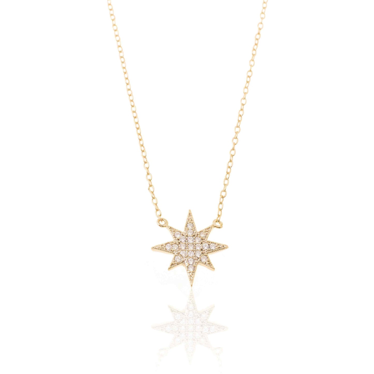 gargantilla con colgante de estrella polar con circonitas. está confeccionada en plata de ley con baño de oro. gold plated sterling silver zircon polar star pendant necklace