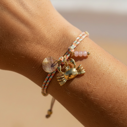 pulsera waterproof o resistente al agua confeccionada con cordón dorado y rosa con abalorios de piedra natural y acero dorado. Cierre ajustable, colgante de concha, pez, cangrejo y abalorios de colores (CORAL, azul TURQUESA, naranja)