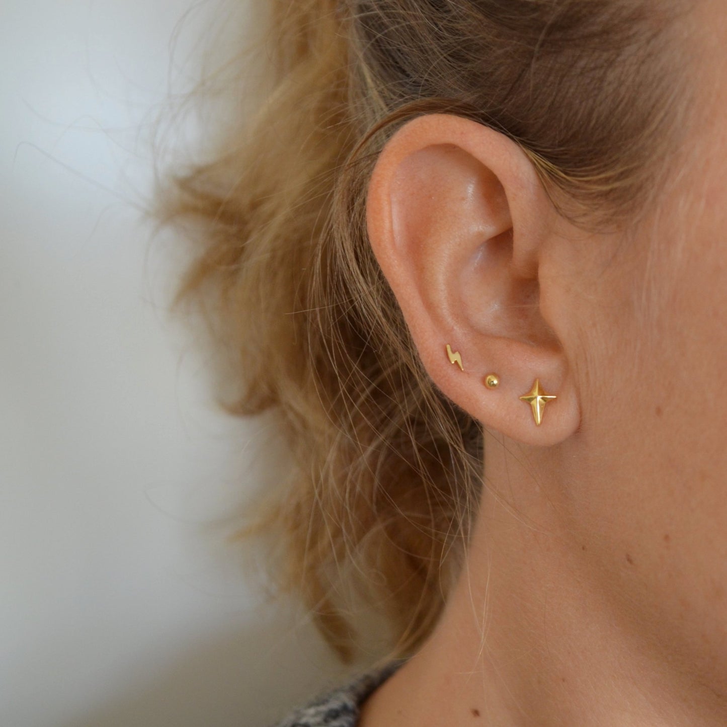 Pequeños pendientes mini de bolitas de 2,5 mm para llevar en agujeros de piercing y que están confeccionados en plata de ley con baño de oro 18 kilates. gold plated sterling silver mini bead earrings for piercing