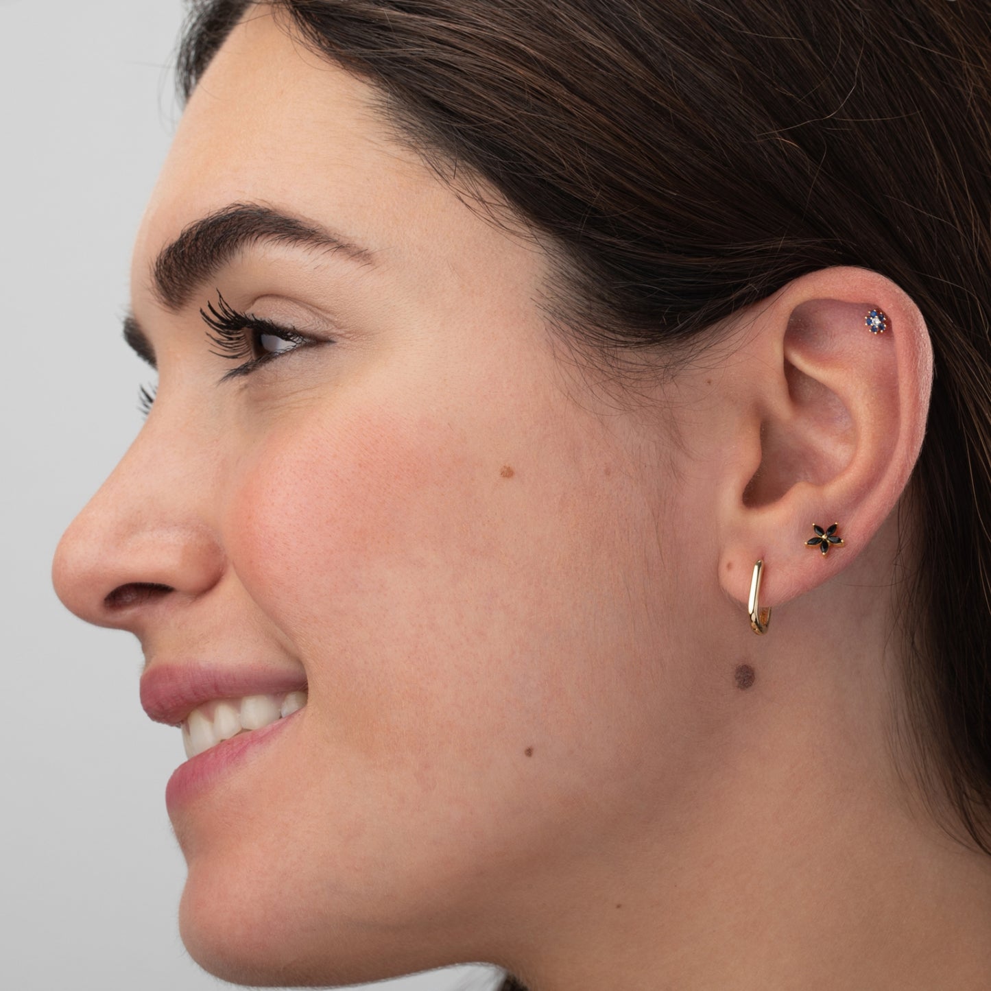 pendiente piercing de flor en acero inoxidable e hipoalergénico bañado en oro 18 kilates. Cierre de bolita. Perfecto para cartílago como helix, tragus, conch. GOld plated stainless steel blue zircon flower cartilage piercing earring.